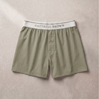 Green boxer shorts with a white waistband on a beige background