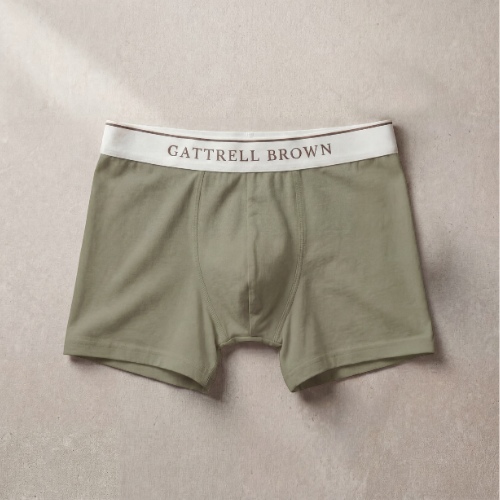 Olive green boxer briefs with a white waistband featuring 'Gattrell Brown' on a beige background.