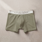 Olive green boxer briefs with a white waistband featuring 'Gattrell Brown' on a beige background.