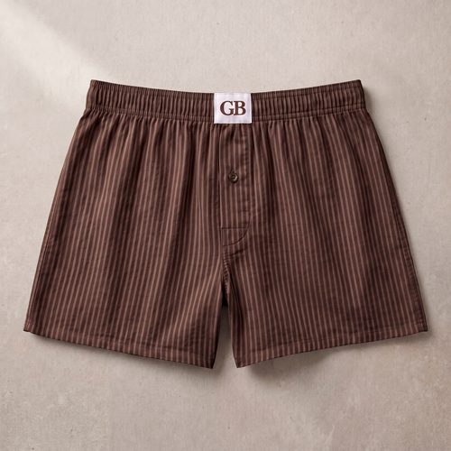 Brown striped boxer shorts with a visible brand label on a beige background