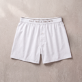 White boxer shorts with 'Gattrell Brown' waistband on a beige background