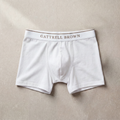 White boxer briefs with 'Gattrell Brown' waistband on a beige background