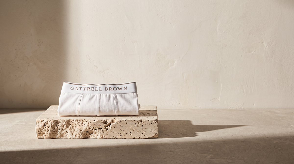 White Original Trunk folded on travertine in morning light